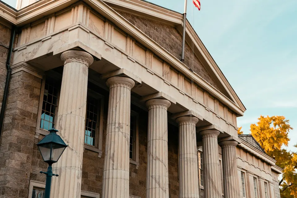 A columned public building with a flag
