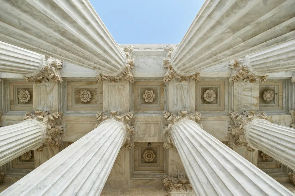 Grey stone columns seen from below