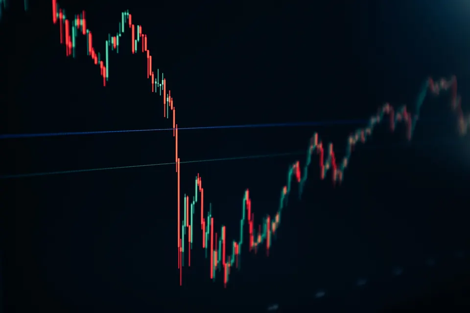 A price chart dropping sharply and partly recovering on a screen